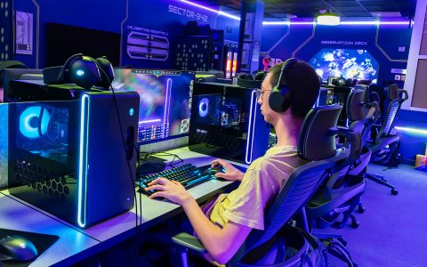 Student playing games at Binghamton University's space-themed Launch Point gaming lounge