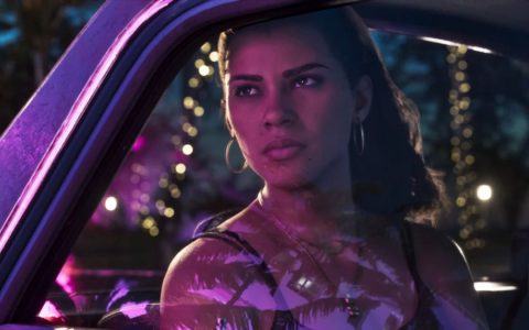 A character driving through a neon-lit city at night in Grand Theft Auto VI