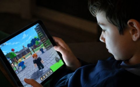 Child playing Roblox on a tablet