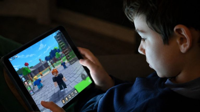 Child playing Roblox on a tablet