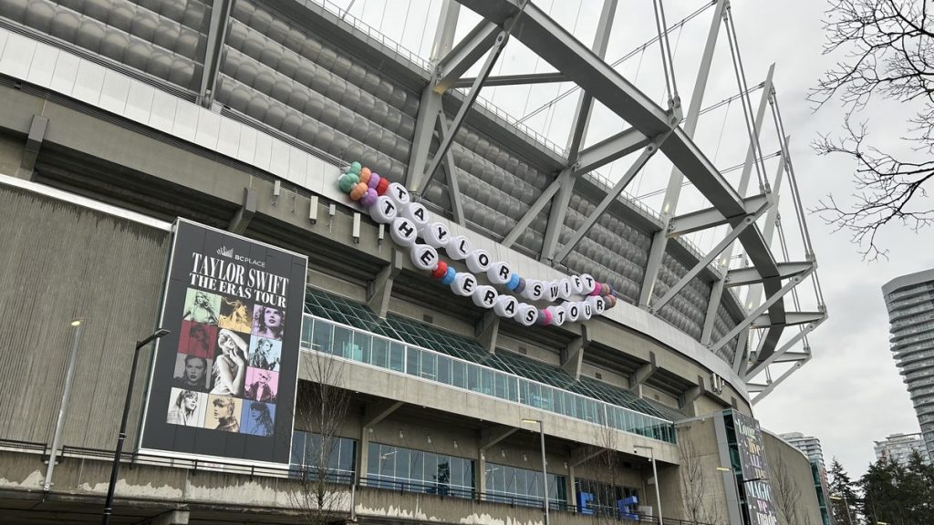 Taylor Swift Eras Tour poster and giant friendship bracelet decoration on the outside of BC Place stadium in Vancouver