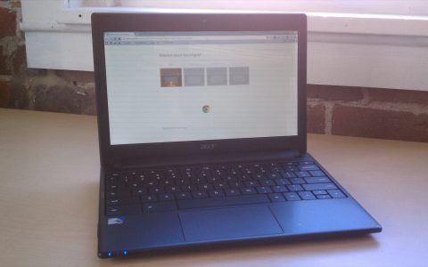 An open Acer Chromebook on a wooden desk with a web browser on screen