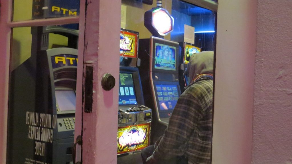 Video gambling machines seen through the front door of a bar