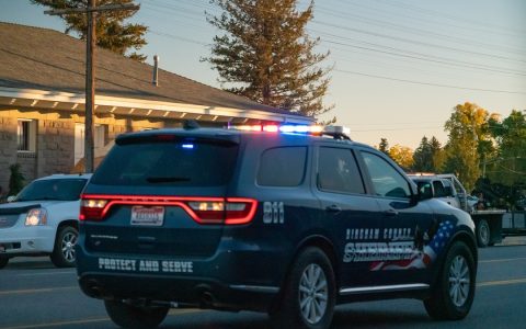 A Bingham County Sheriff’s Office SUV with its lights on, driving on a street in Blackfoot, Idaho