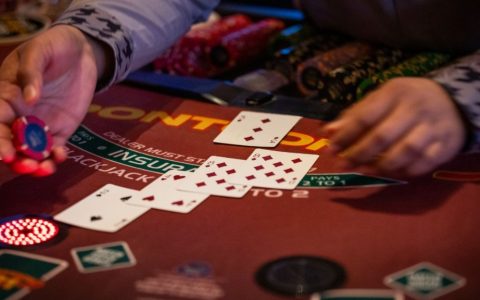 Close-up of a blackjack table in a casino with playing cards and gambling chips