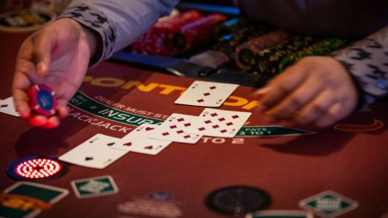 Close-up of a blackjack table in a casino with playing cards and gambling chips