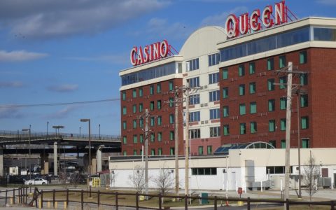 Casino Queen hotel and casino building with red CASINO QUEEN signs in East St. Louis, Illinois