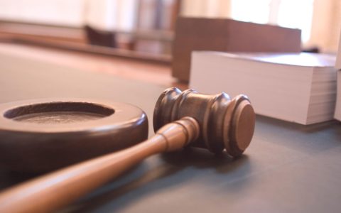 A judge's gavel on a courtroom desk
