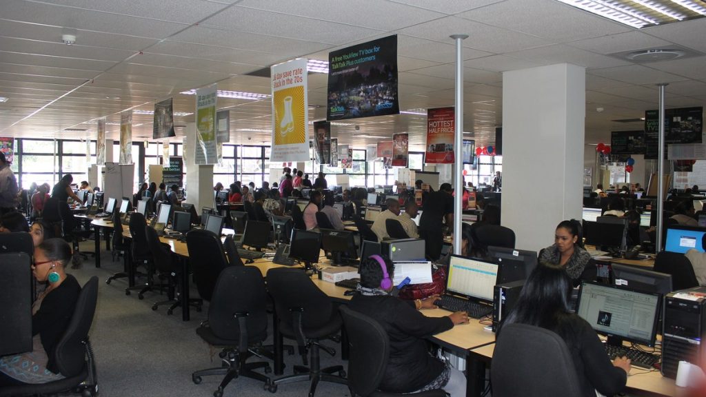 Rows of staff working at computers in a call centre