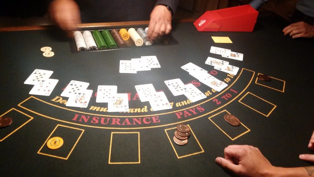 A dealer deals cards at a blackjack table