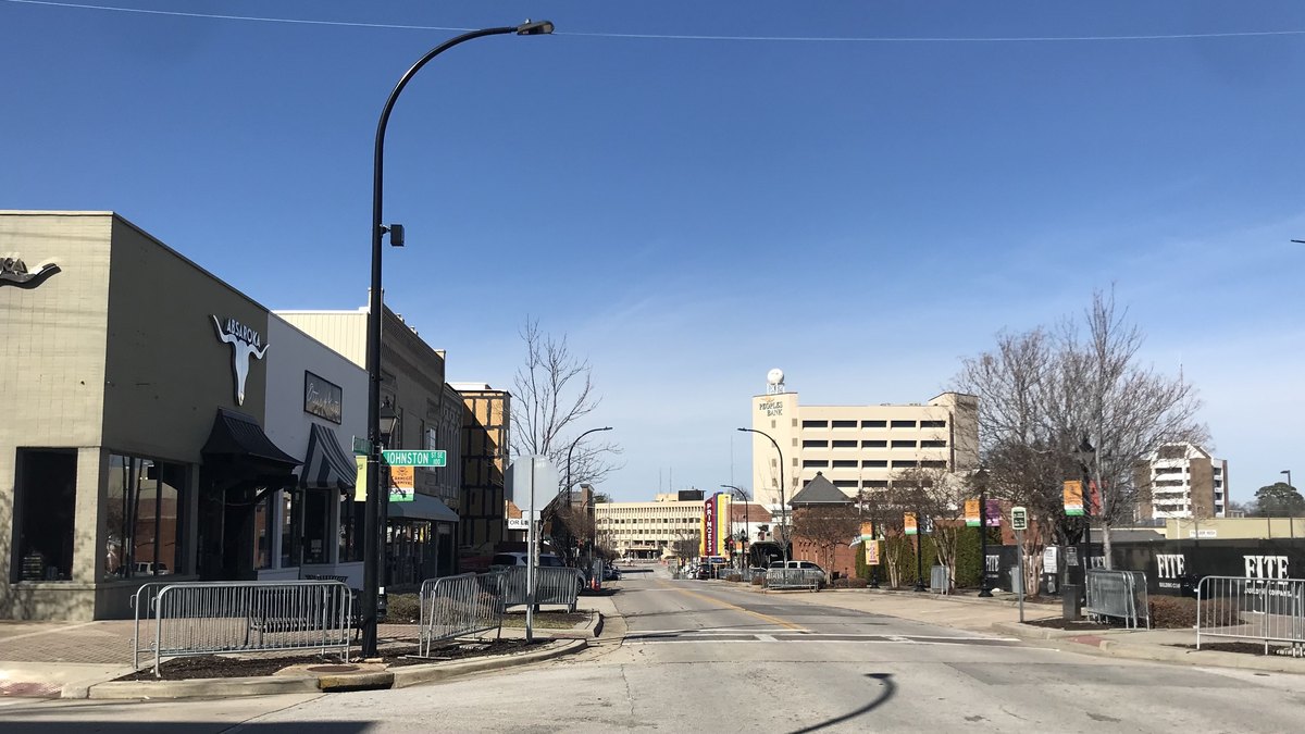 A downtown street in Decatur, Alabama, with shops on the left and office buildings in the distance