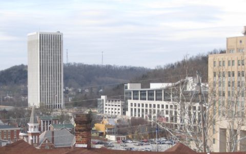 Buildings of downtown Frankfort, Kentucky, including a tall office tower, seen from across the Kentucky River