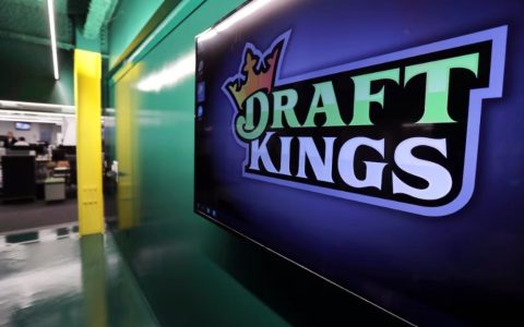 DraftKings corporate logo displayed on an office monitor