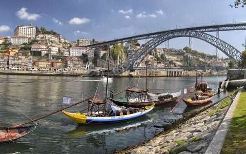 Rabelo boats on the Douro river at Vila Nova de Gaia with Porto and the Dom Luis I bridge behind