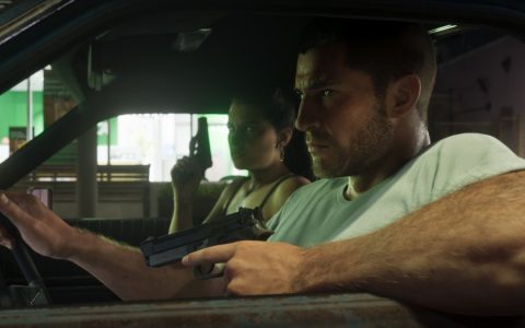Jason drives with Lucia holding a pistol in the passenger seat in Grand Theft Auto VI