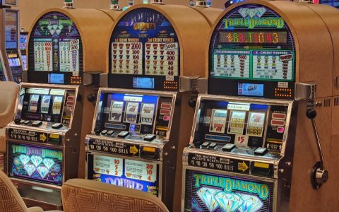 Three IGT Double Diamond and Triple Diamond slot machines on a casino floor