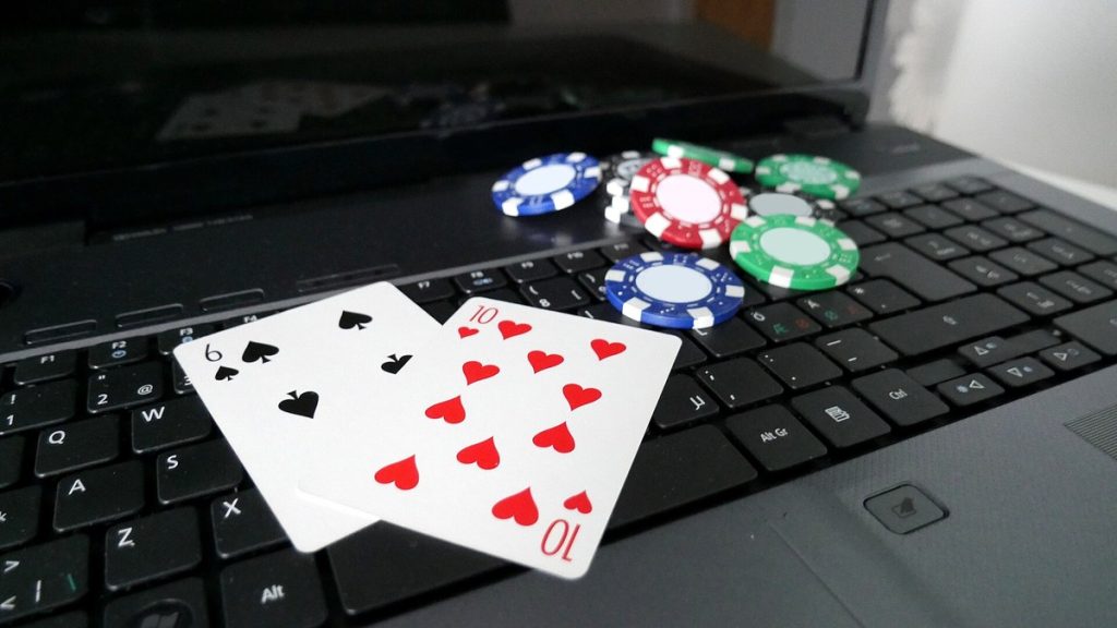 Poker chips and playing cards on a laptop keyboard
