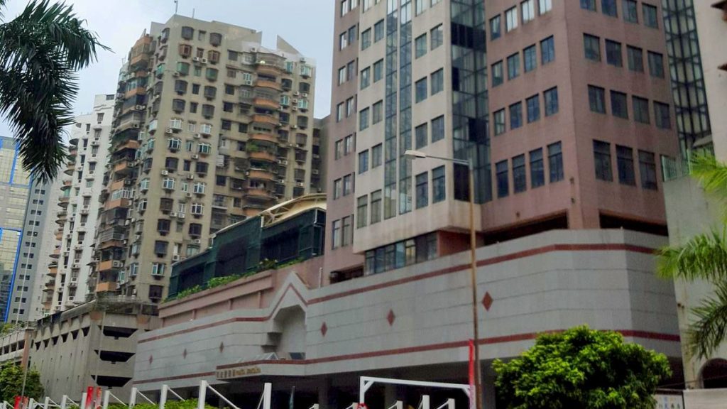 The Judiciary Police building in Macau, a tall glass-and-stone tower