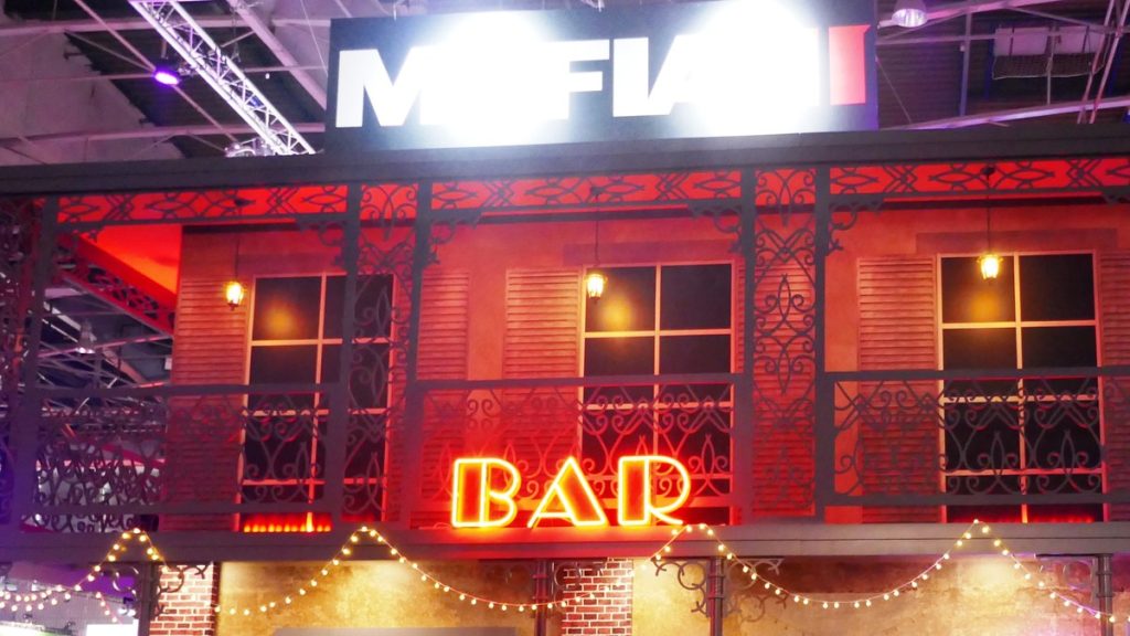 Mafia III stand styled as a New Orleans building with a neon BAR sign at Paris Games Week 2016