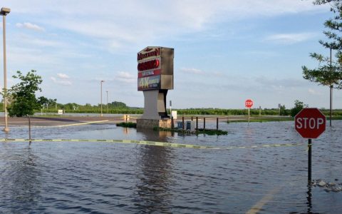 Mark Twain Casino roadside sign in La Grange, Missouri, with floodwater covering part of the parking lot
