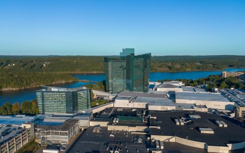 Aerial view of the Mohegan Sun casino resort and its glass hotel towers beside the Thames River in Uncasville, Connecticut