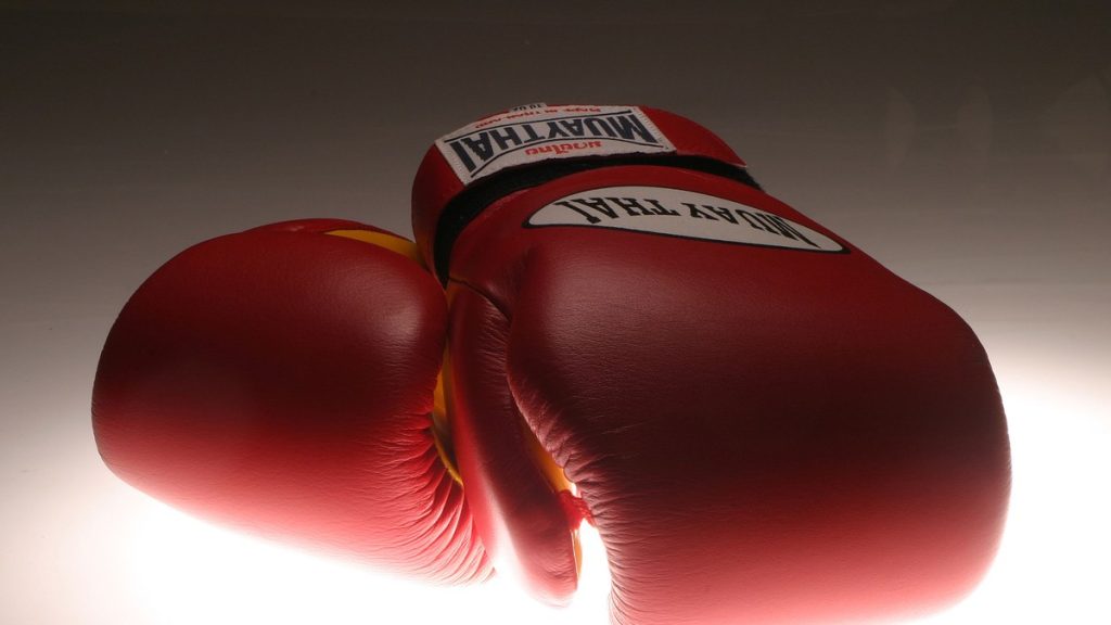 A pair of red Muay Thai boxing gloves