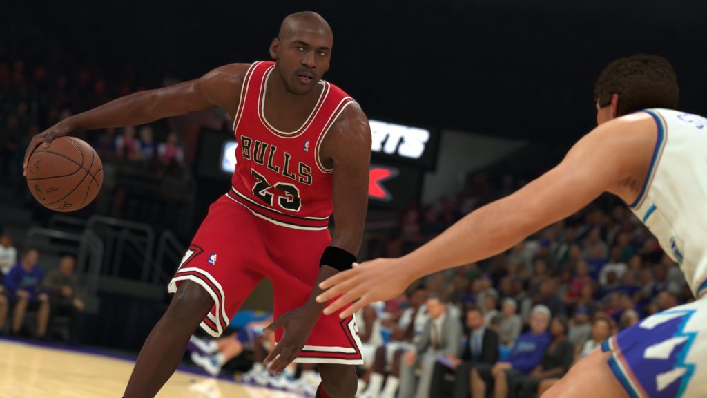 Michael Jordan in a red Chicago Bulls No. 23 jersey dribbling past a defender in NBA 2K23