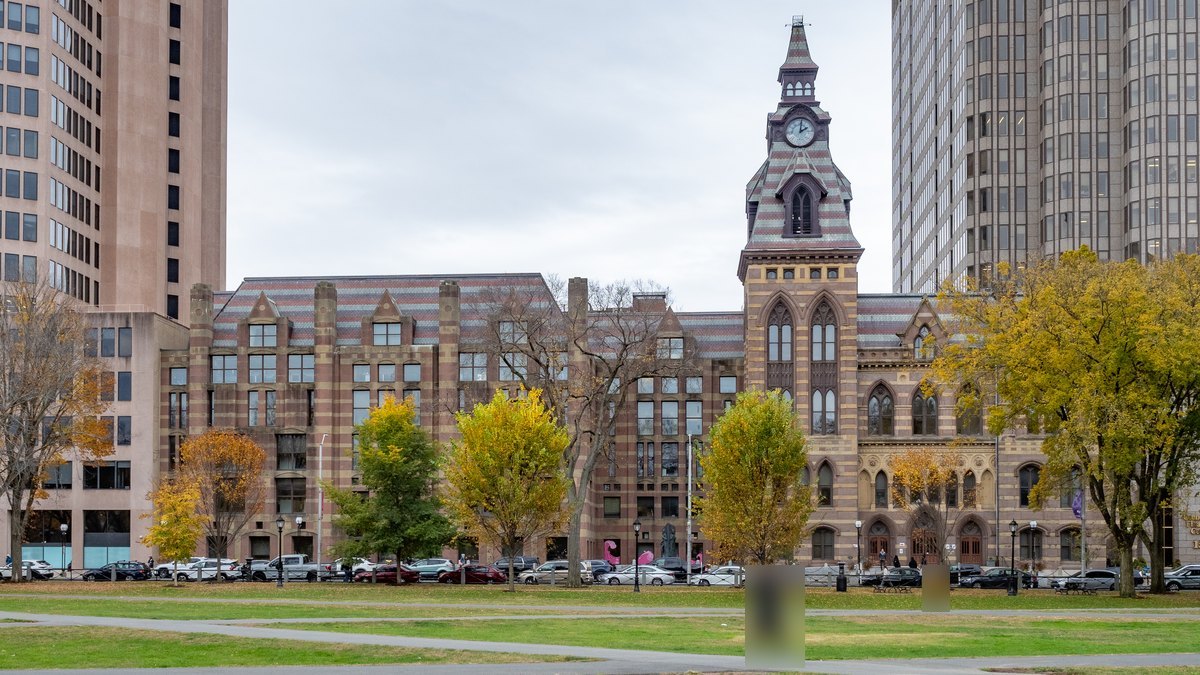 New Haven City Hall, a Victorian Gothic building with a clock tower, seen across the New Haven Green