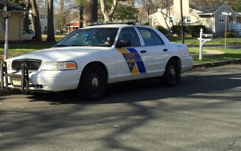 A white New Jersey State Police patrol car parked on a residential street