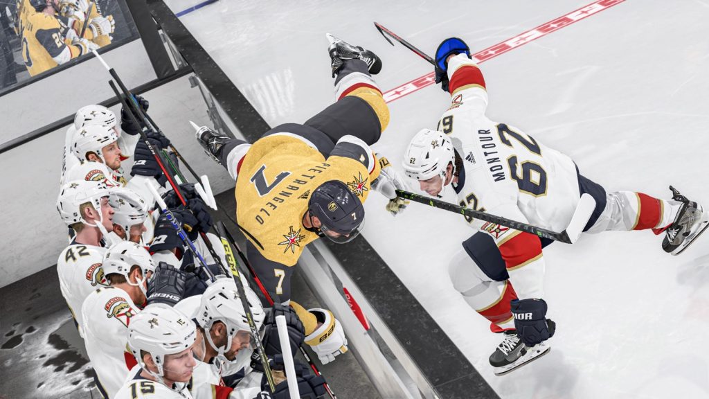 A Vegas Golden Knights player tumbles over the boards into the Florida Panthers bench during a body check in NHL 24