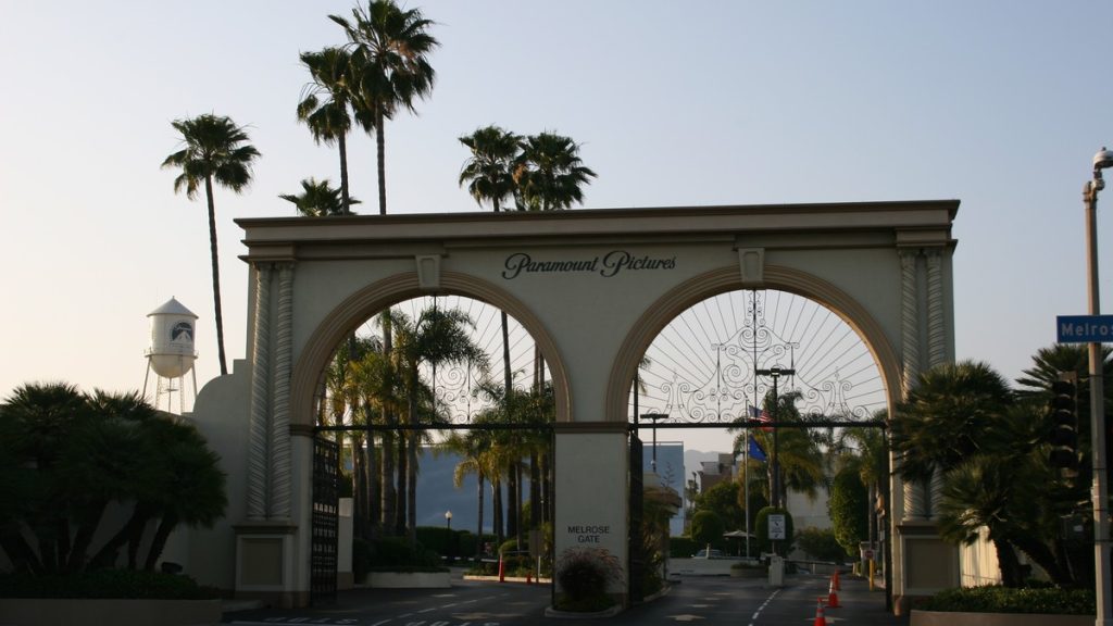 The arched Melrose Gate entrance of the Paramount Pictures studio lot, framed by palm trees