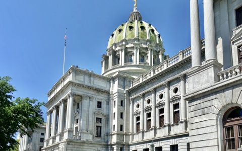 The domed Pennsylvania State Capitol building in Harrisburg under a blue sky