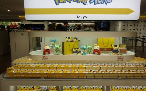 A Pokémon Store display of plush toys and boxed merchandise