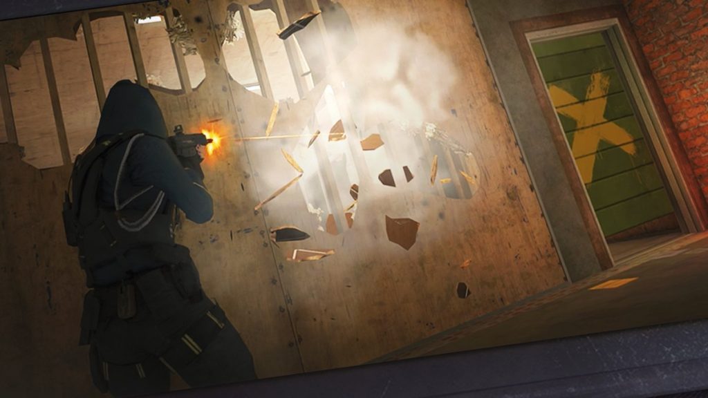 An operator firing through a breached wooden wall in Rainbow Six Mobile