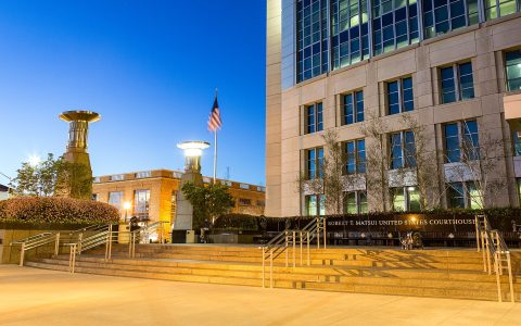 Robert T. Matsui United States Courthouse in Sacramento at dusk, with its name on the plaza wall