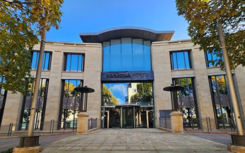 The stone and glass front of Rockstar North headquarters in Edinburgh with the studio name above the entrance