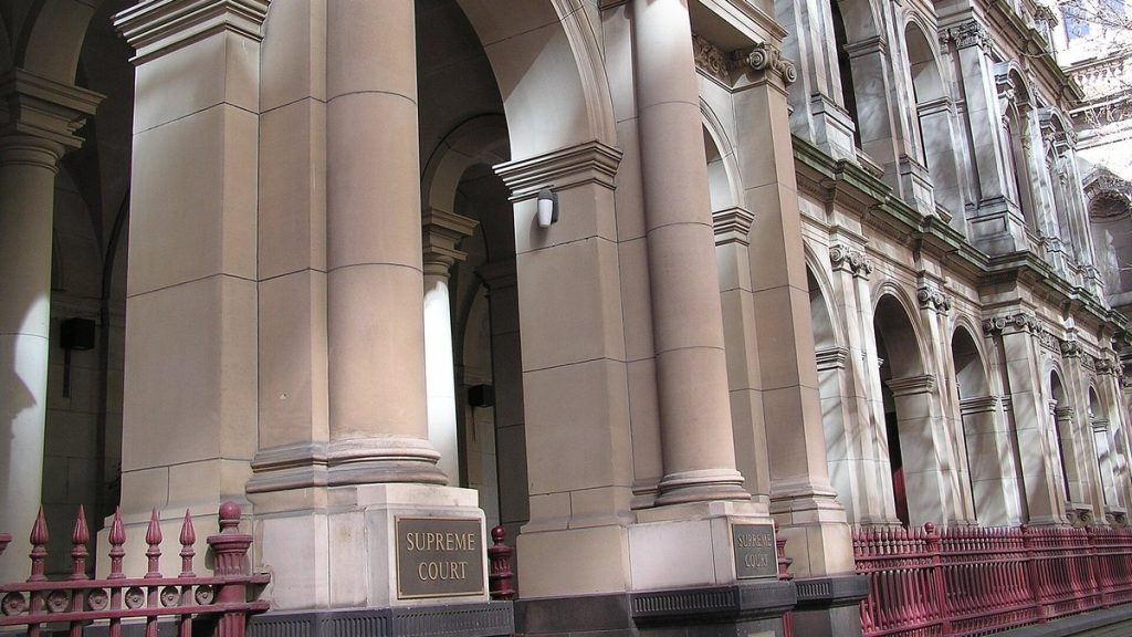 Sandstone columns and a Supreme Court sign at the Supreme Court of Victoria in Melbourne