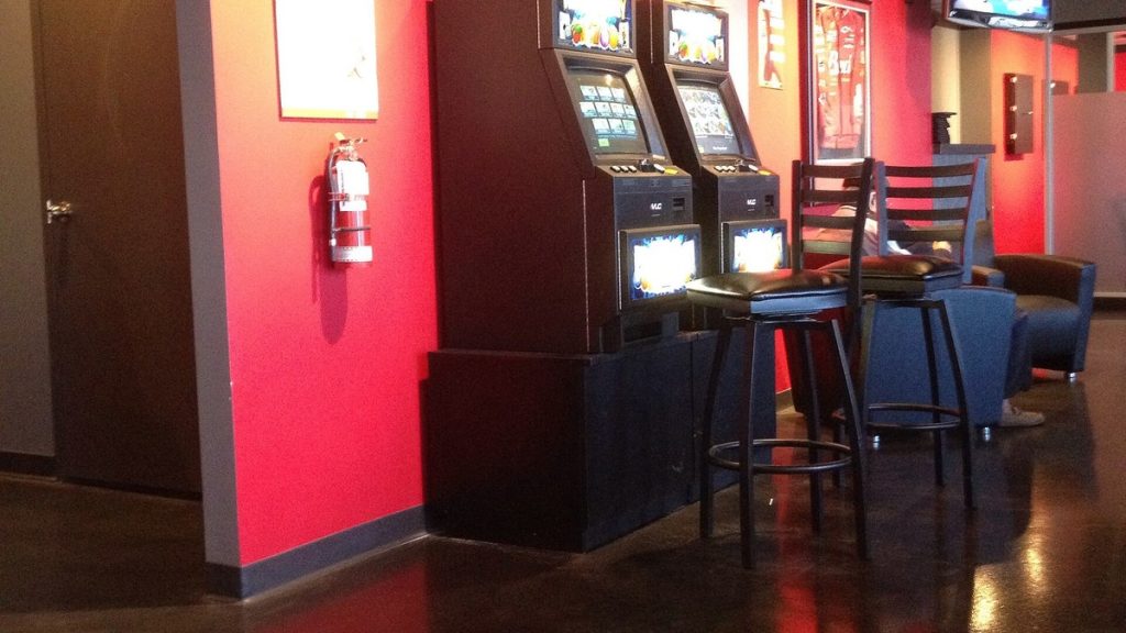 Video gaming terminals beside bar stools in a bar