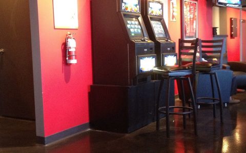 Video gaming terminals beside bar stools in a bar