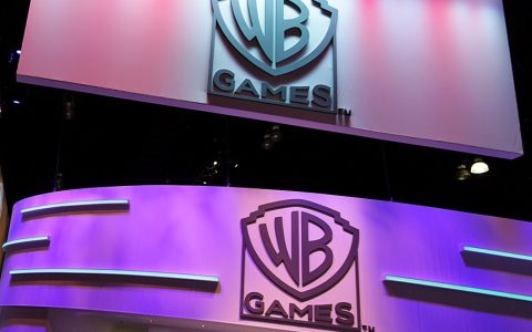 Warner Bros. Games logos on the publisher’s booth at a games trade show