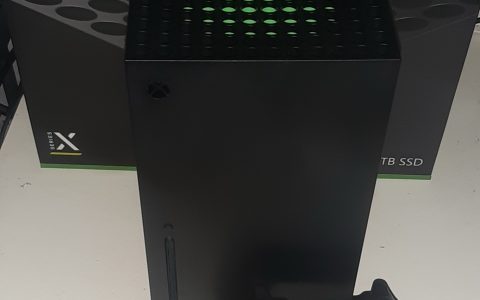 An Xbox Series X console and its controller standing in front of the console’s box
